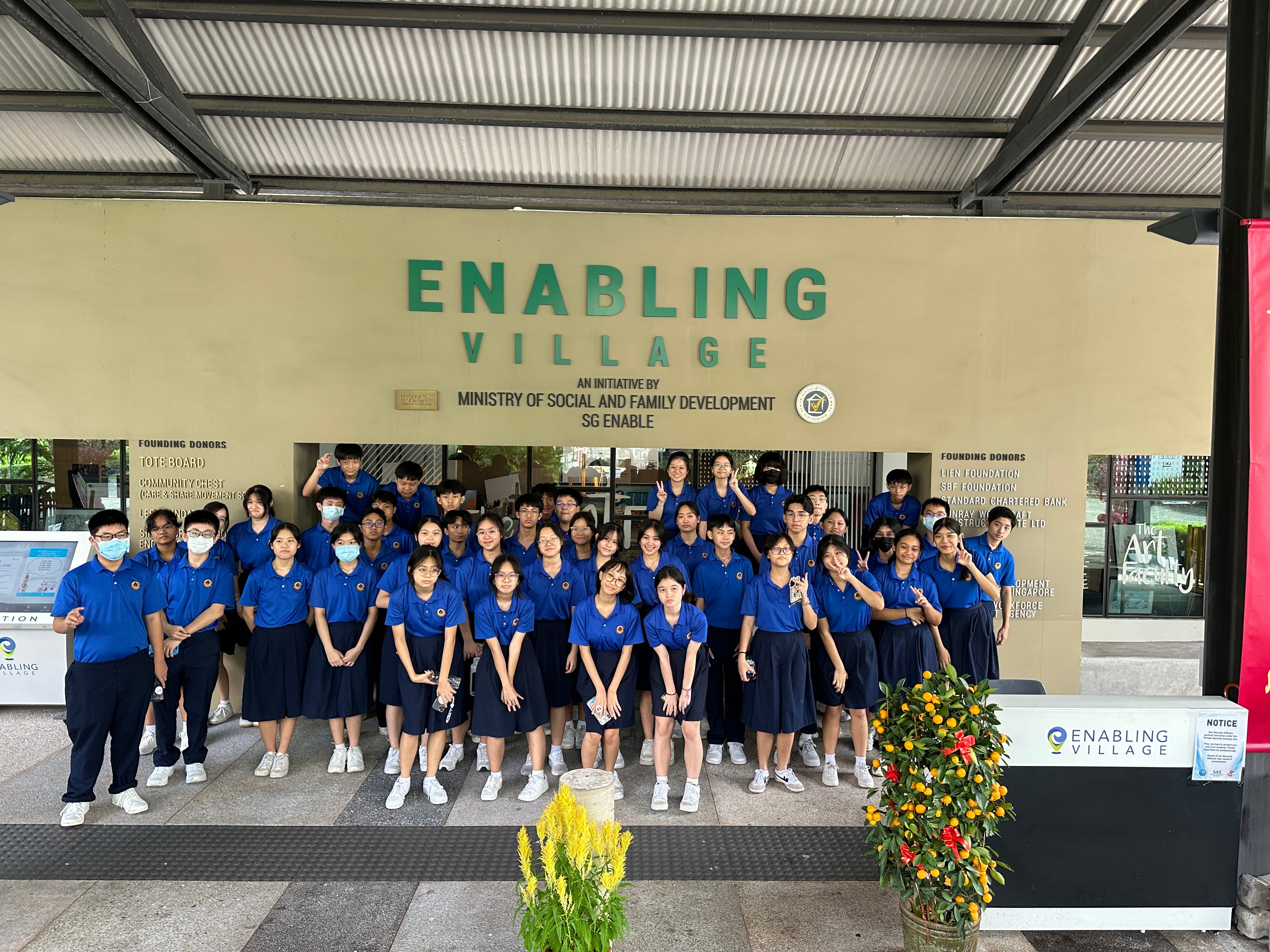 Students visited the Enabling Village and posing together for a photo